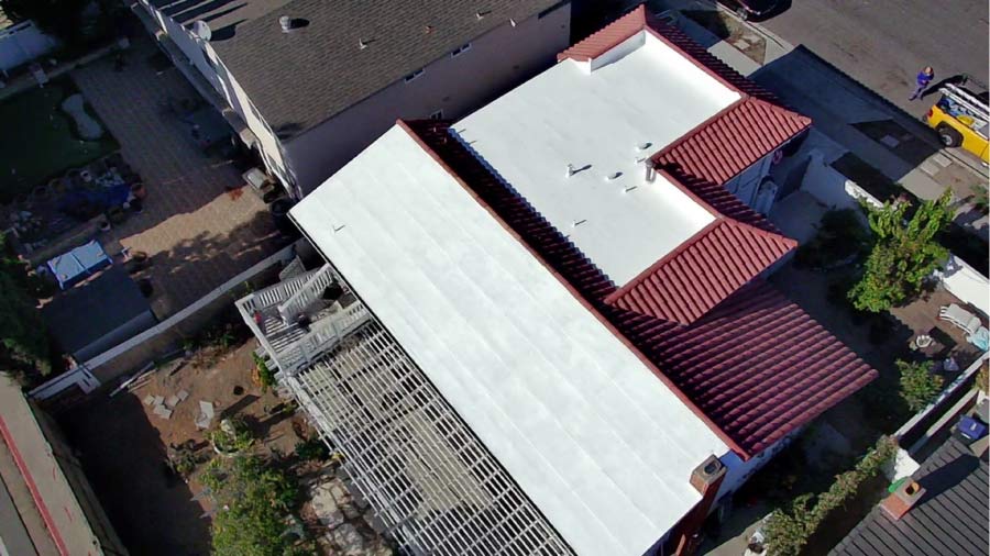 Aerial view of a low-slope roof restoration using APOC silicone coatings in Fountain Valley, California