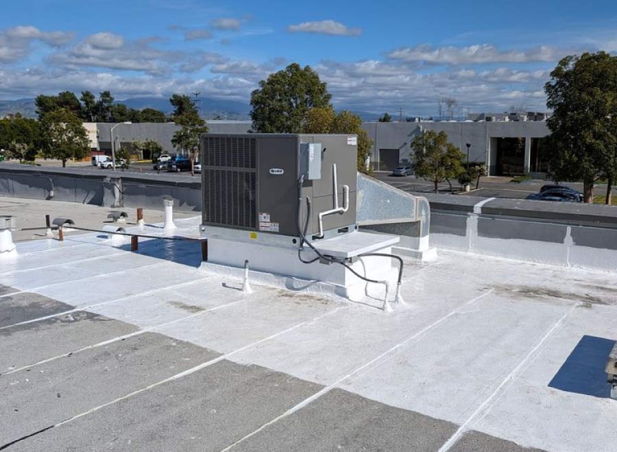 Commercial flat roof with reflective coating and rooftop HVAC unit