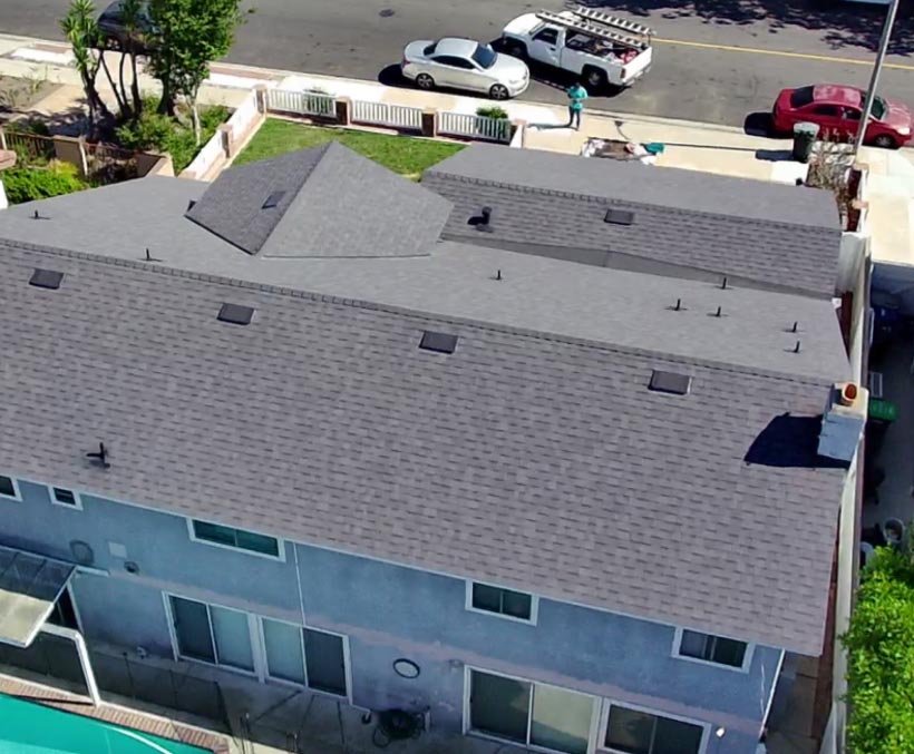 completed-roofing-project Aerial view of a completed asphalt shingle roof replacement on a two-story home