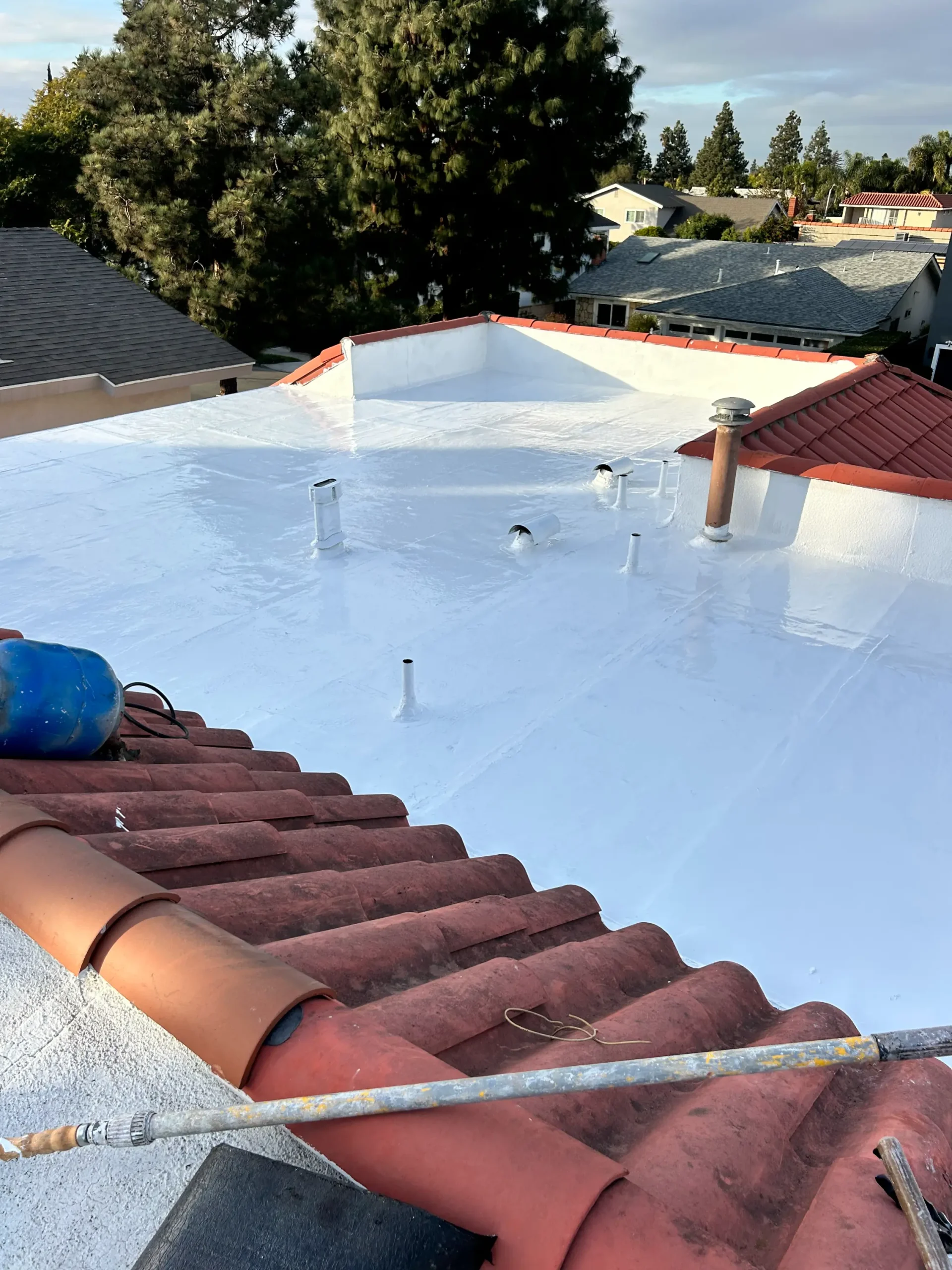 Roof coating in progress using APOC silicone roof coatings in Fountain Valley, California